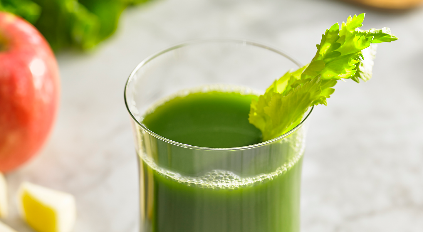 Green juice in a glass with celery