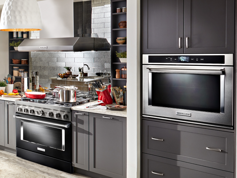 Kitchen with gray cabinetry, gas range and single wall oven 