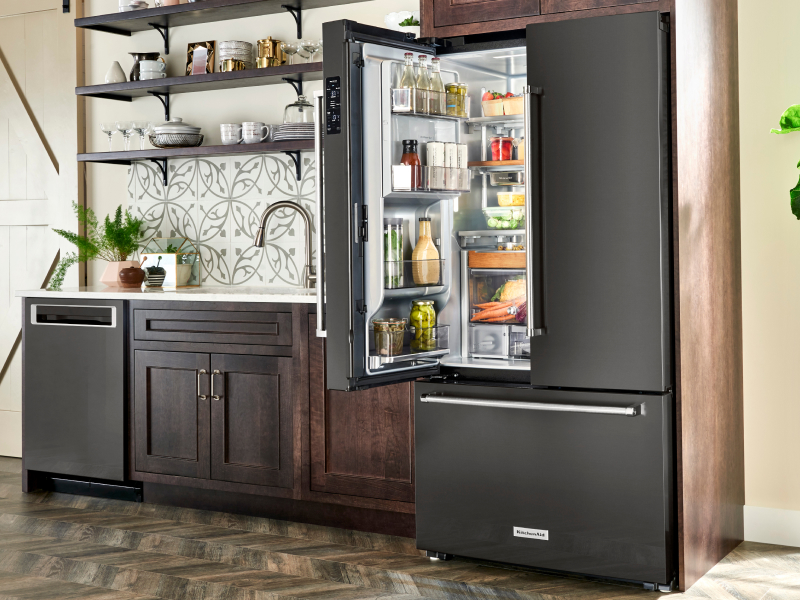 Open French door refrigerator with food inside