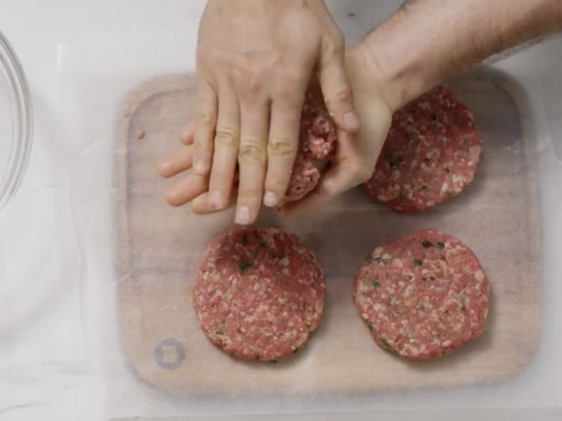 Person forming four patties from ground beef
