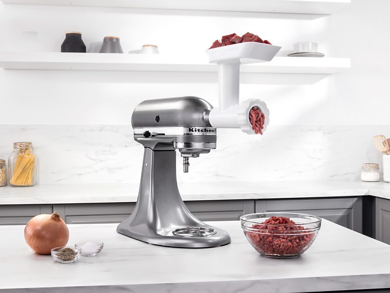 Silver KitchenAid® stand mixer with Meat Grinder Attachment grinding beef 