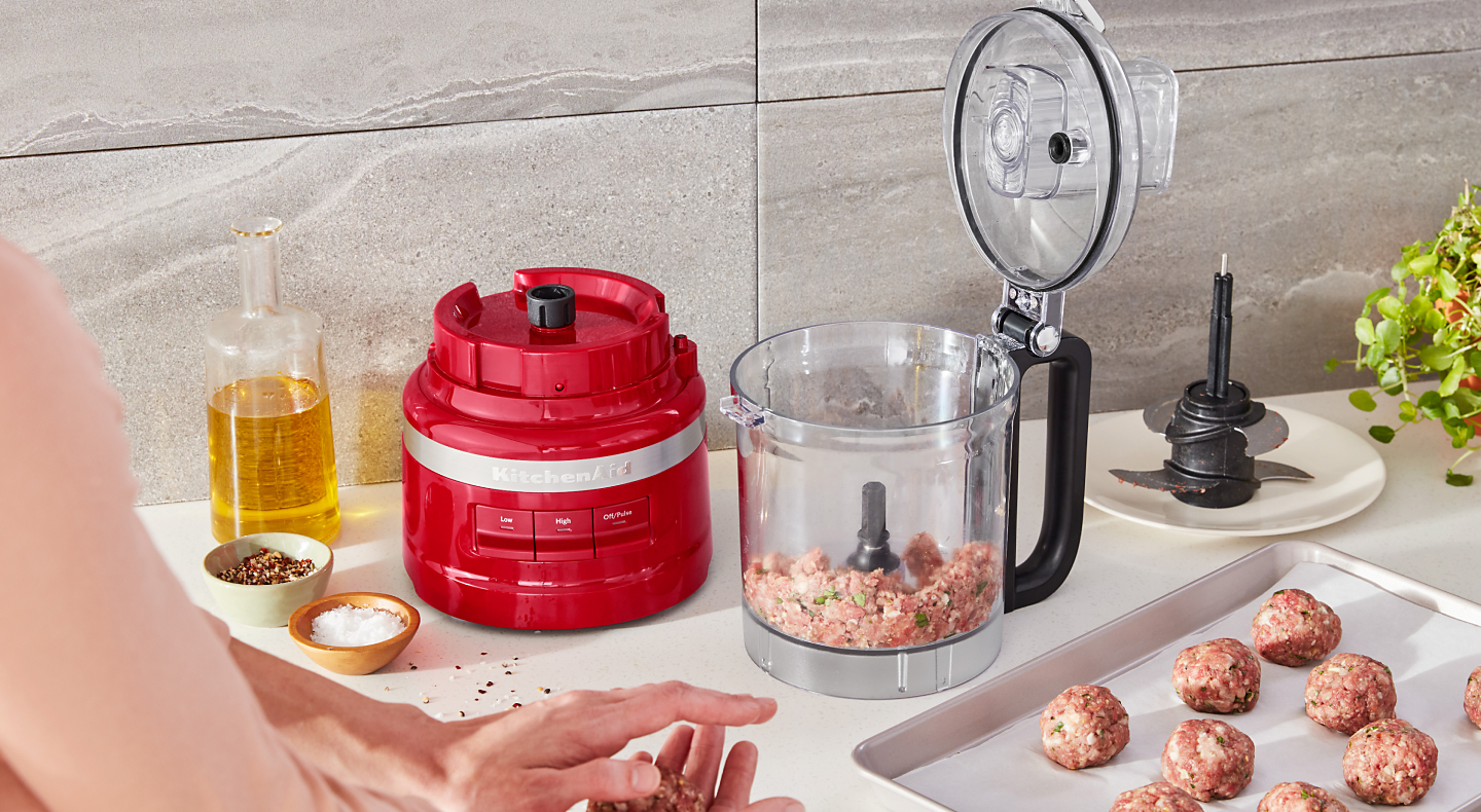 Ground beef inside a red KitchenAid® food processor
