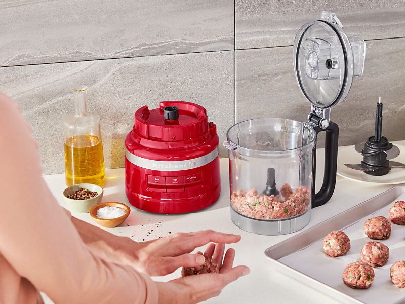 Ground beef inside a red KitchenAid® food processor