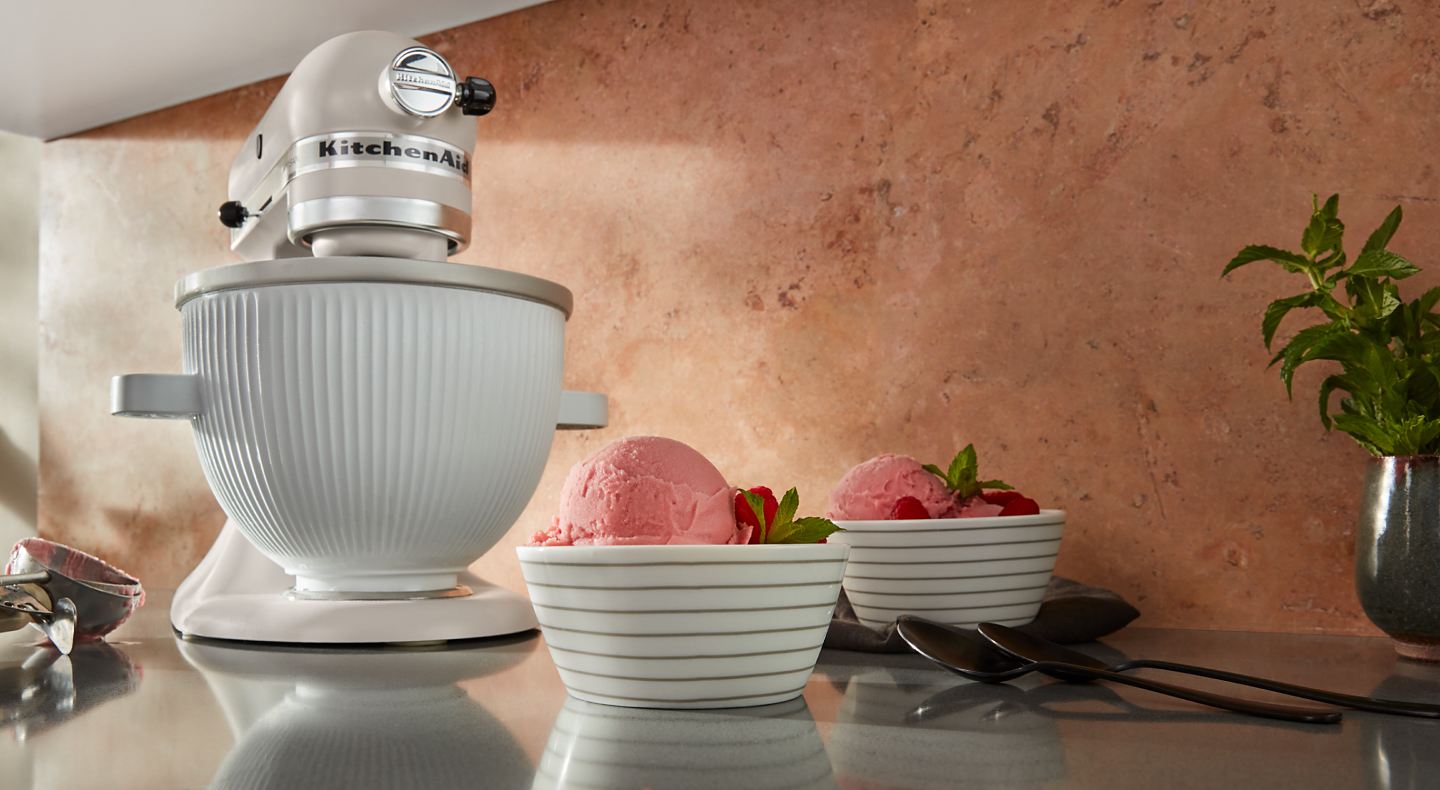 KitchenAid® stand mixer on countertop with two bowls of ice cream