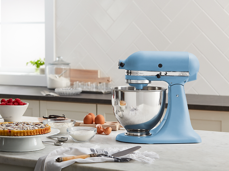 A light blue KitchenAid® stand mixer next to various ingredients