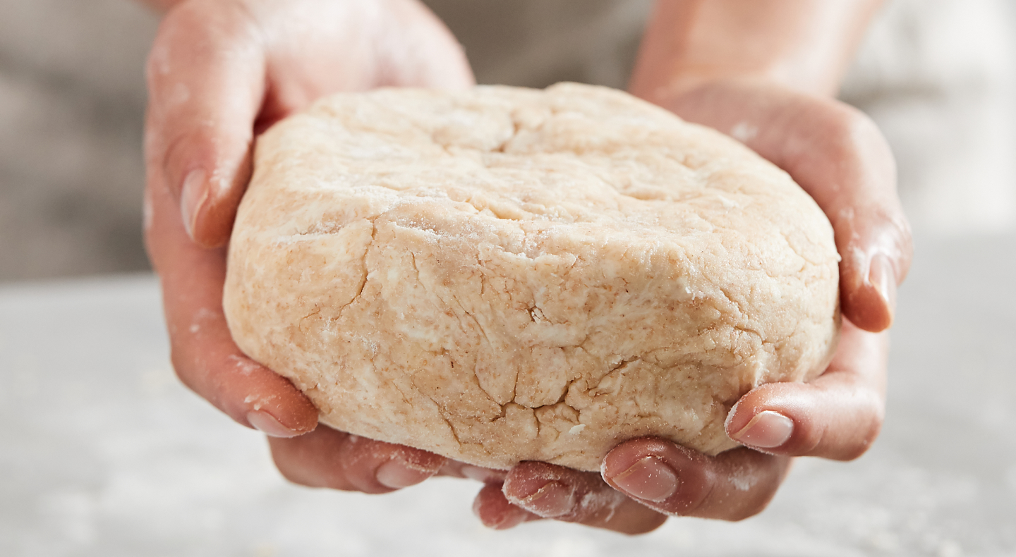 Kneaded dough in a person's hands