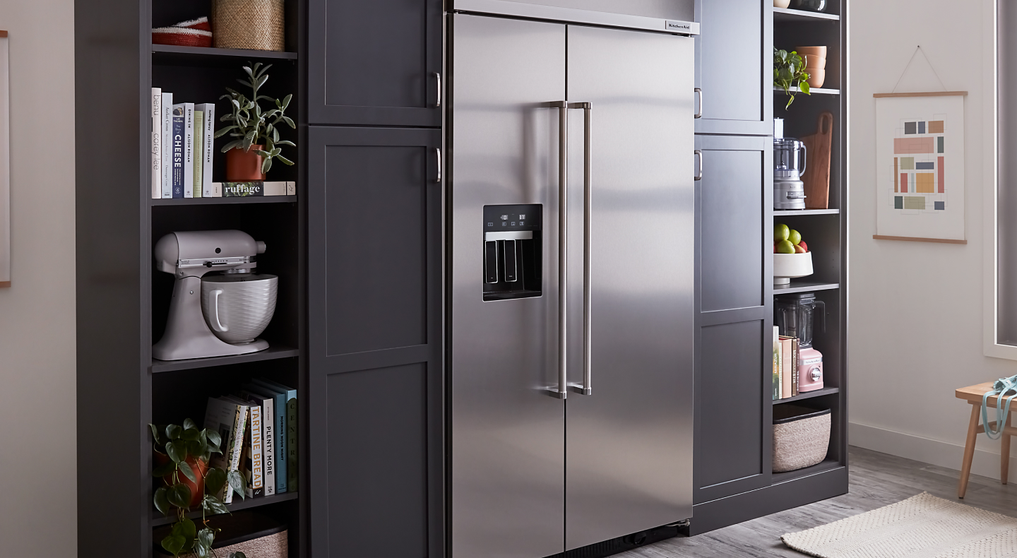 A stainless steel KitchenAid® side-by-side fridge in a kitchen