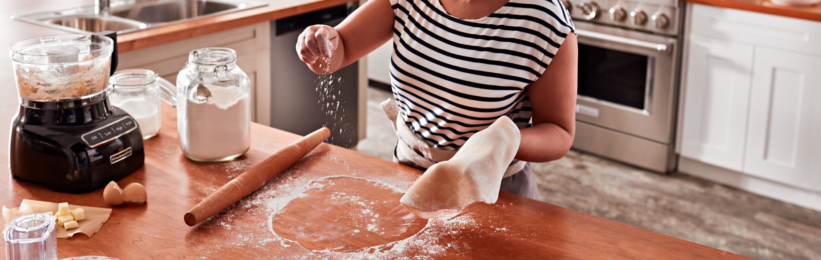 A woman preparing dough
