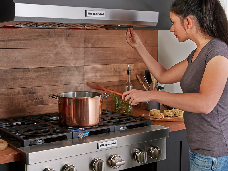 A saucepan boiling on a KitchenAid® cooktop