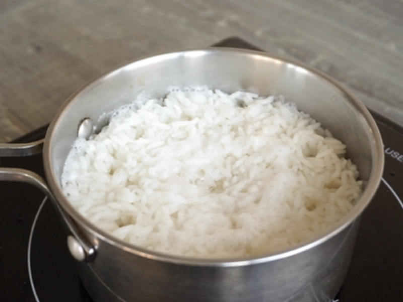 A bowl of rice on a hotpad