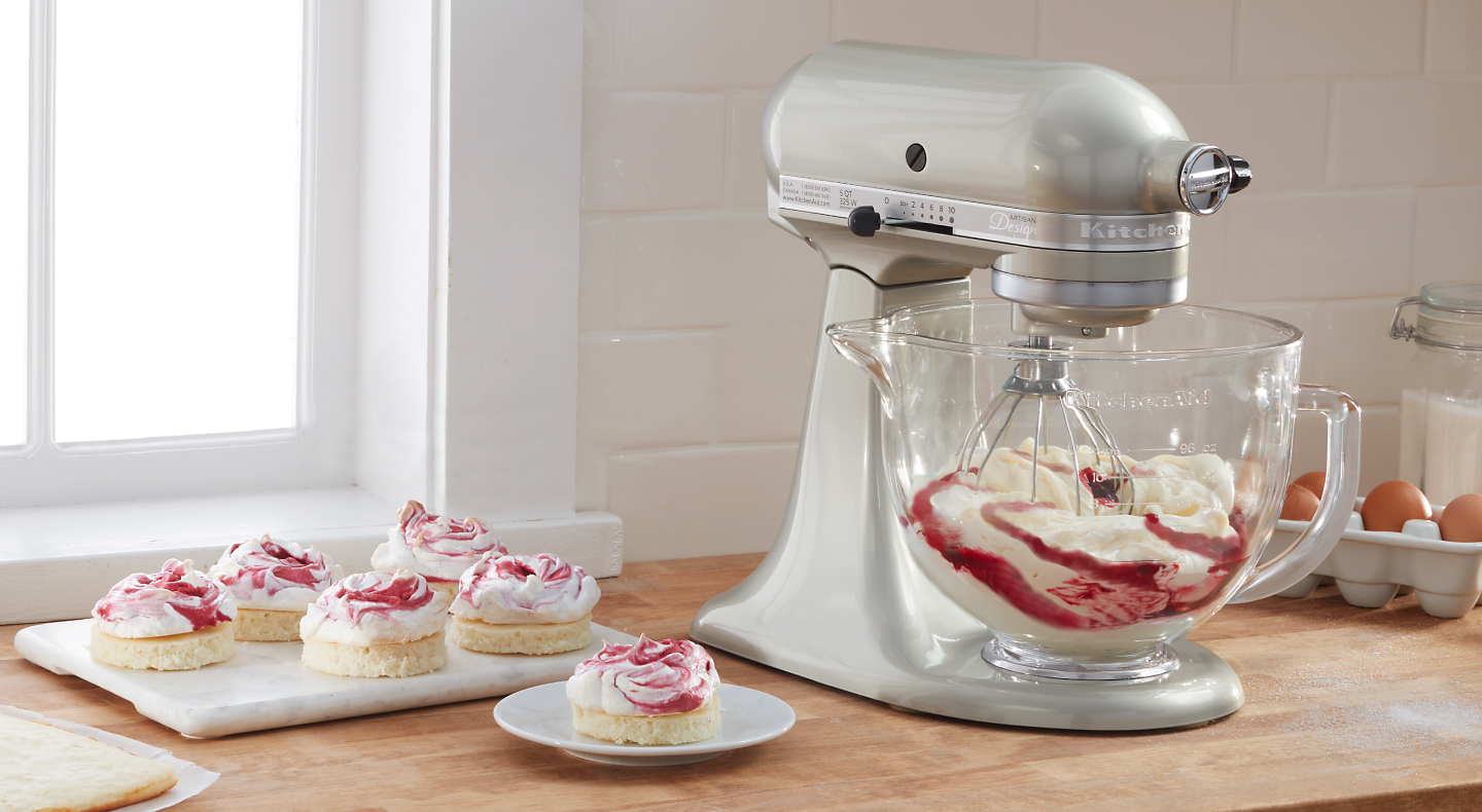 KitchenAid® stand mixer mixing whipped cream with fruit sauce
