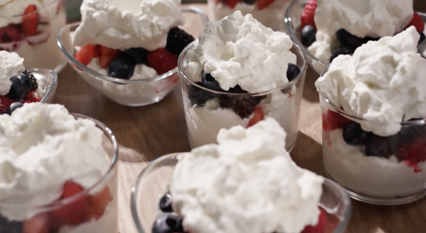 Fruit parfait topped with whipped cream