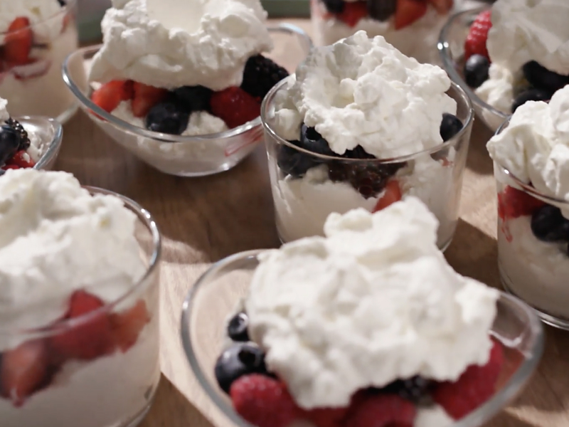 Fruit parfait topped with whipped cream