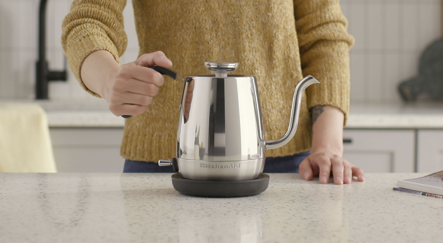 Maker setting stainless steel KitchenAid® electric kettle on countertop