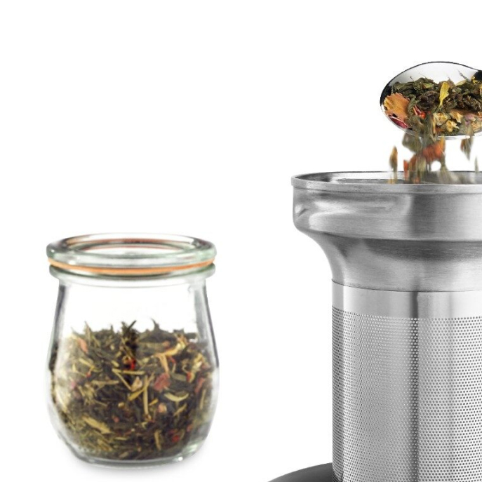 Spoon pouring loose leaf tea into diffuser