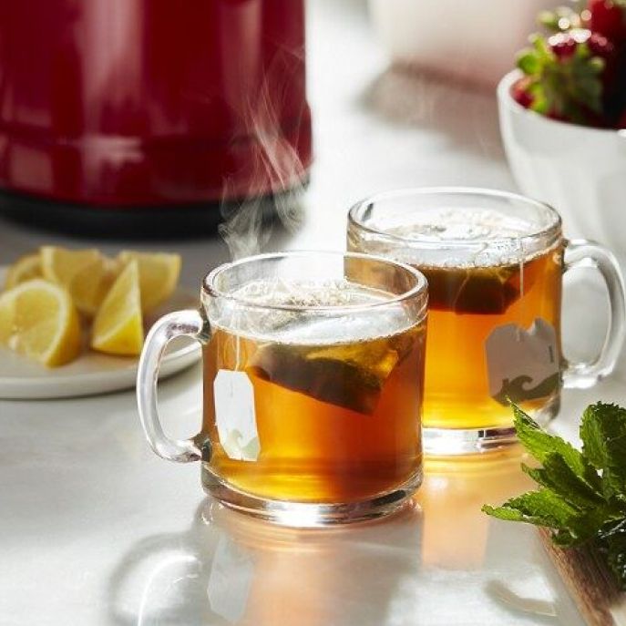 Two glasses of tea on counter with mint and lemons