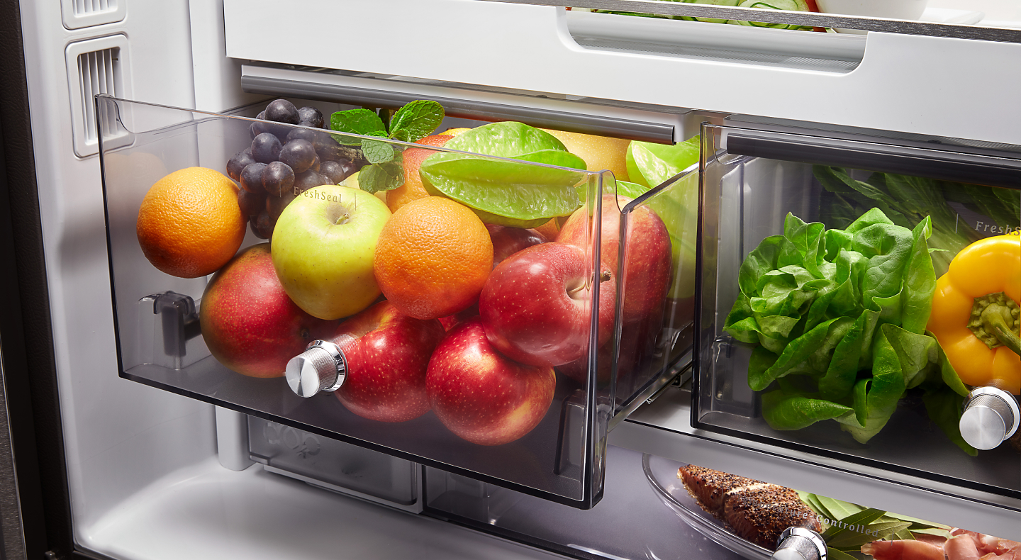 A variety of fruits, vegetables and ingredients in a KitchenAid® FreshSeal Crisper Drawer