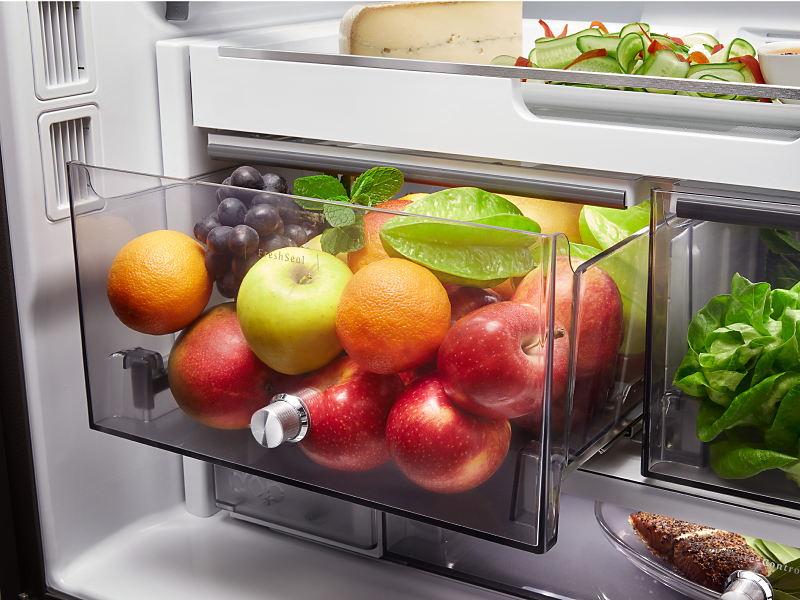 A variety of fruits, vegetables and ingredients in a KitchenAid® FreshSeal Crisper Drawer