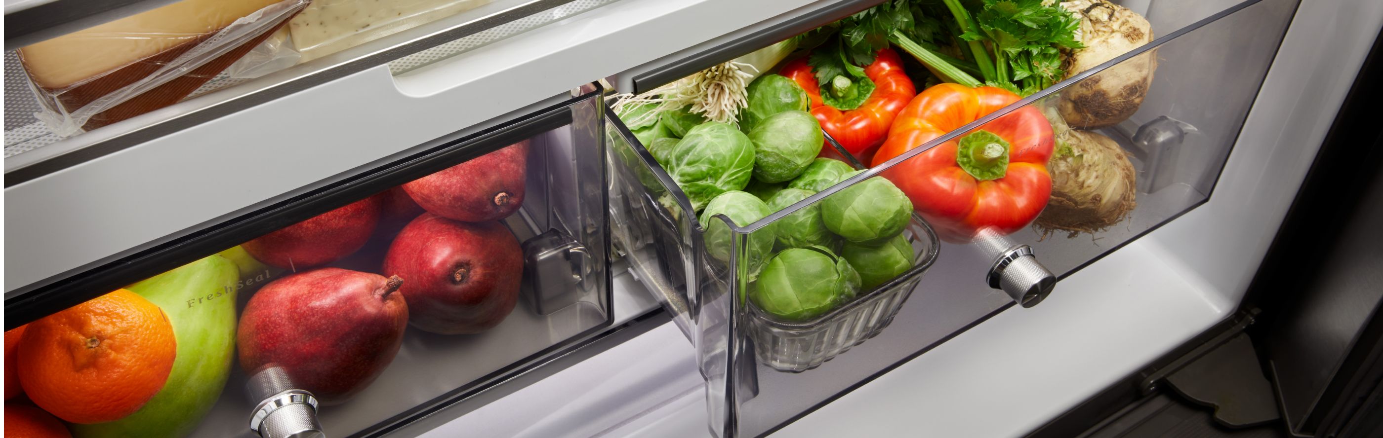 Fresh fruits and vegetables stored in a refrigerator crisper drawer