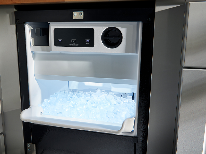 An open ice maker drawer