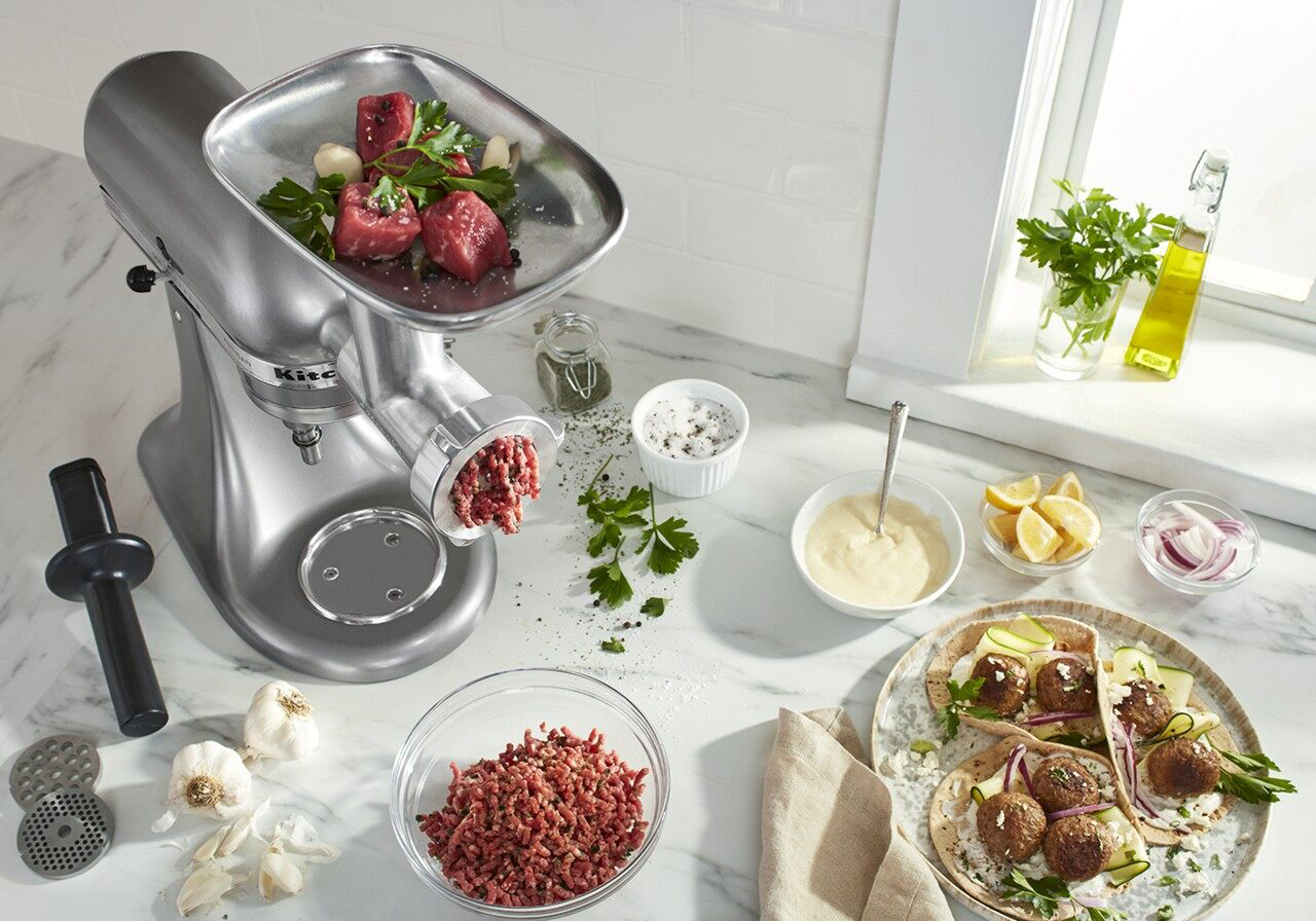 Kitchenaid® food and meat grinder attachment on silver stand mixer grinding meat