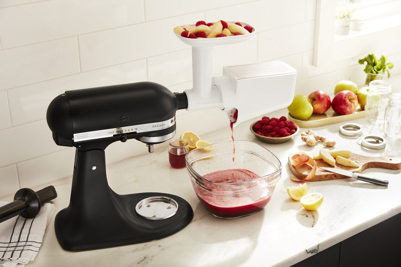 kitchenaid® fruit and vegetable strainer attachment on black stand mixer pureeing fruit