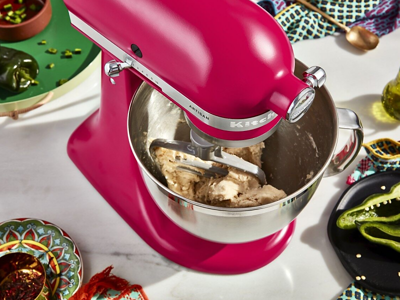 Chicken being shred in bowl of KitchenAid® stand mixer