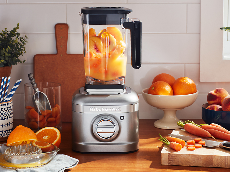 KitchenAid® blender with oranges fruits and carrots on countertop