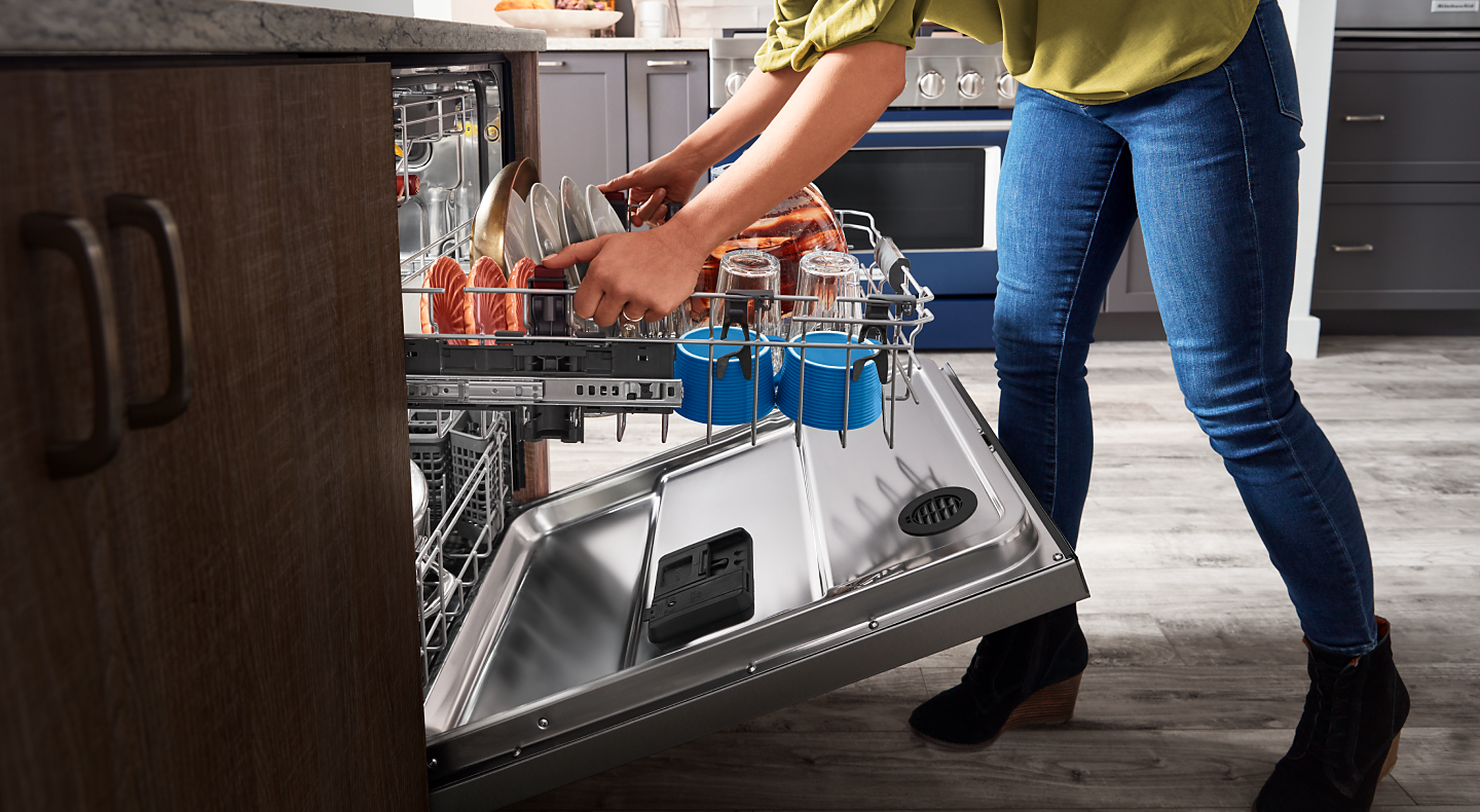 Person adjusting a dishwasher rack