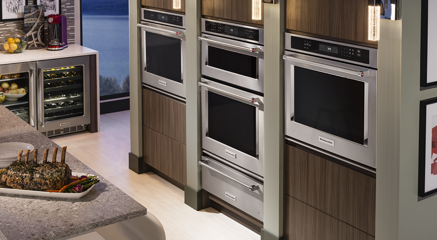 A double wall oven between two single wall ovens