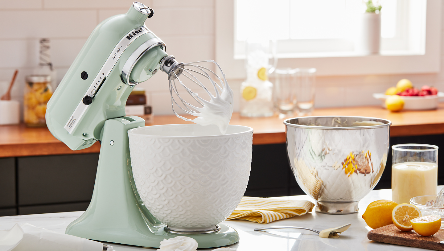 Mint green KitchenAid® stand mixer with ceramic bowl and whisk attachment