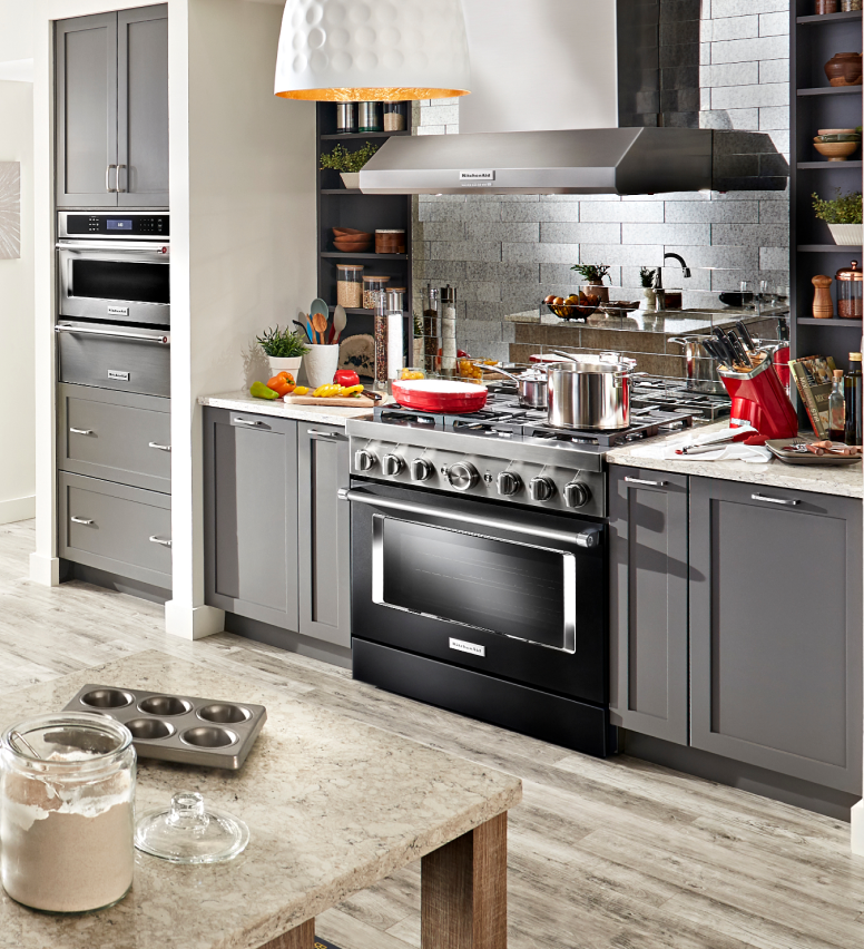 A wall of KitchenAid® appliances installed into a sleek, modern kitchen.