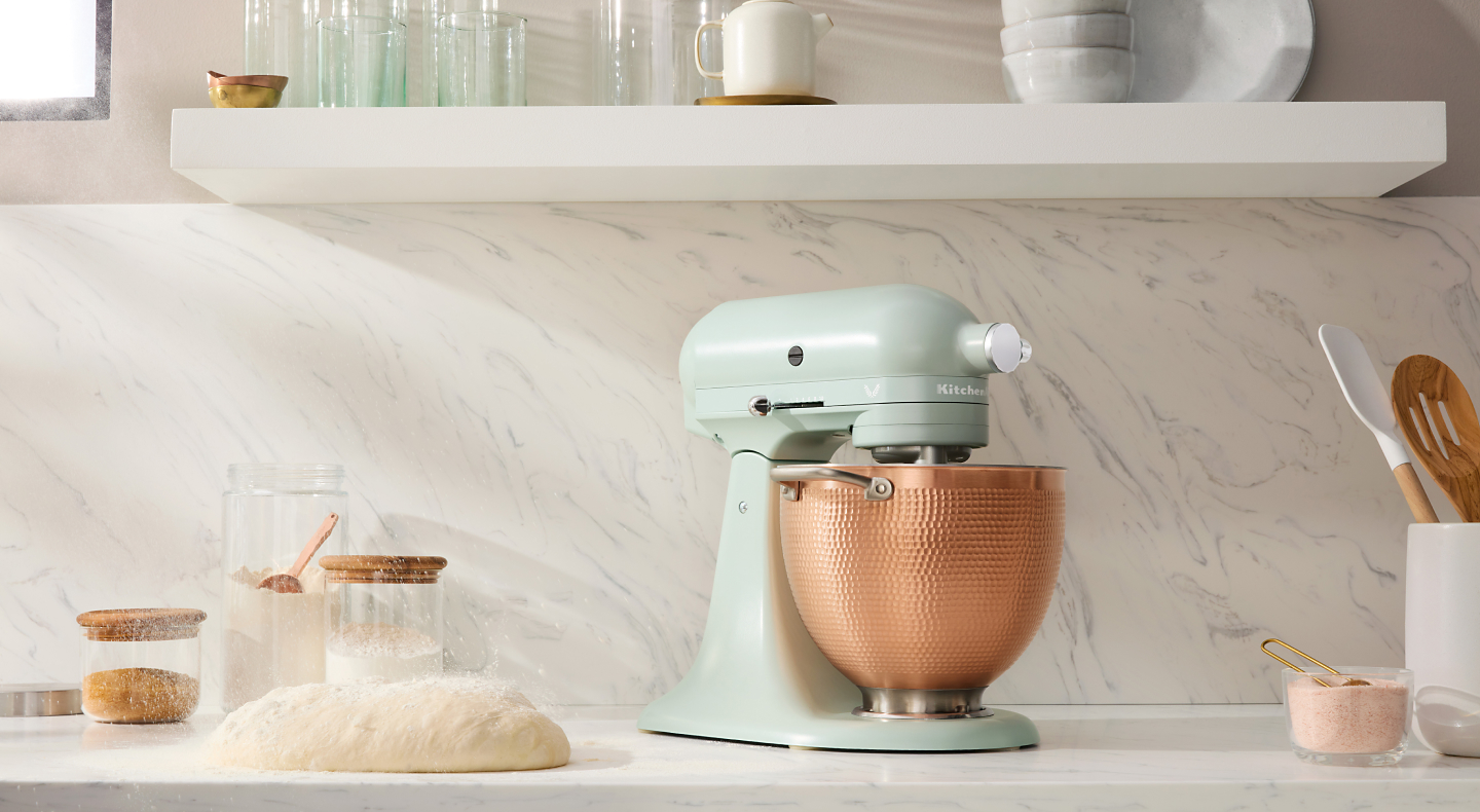 Mint green KitchenAid® stand mixer with a textured, gold bowl