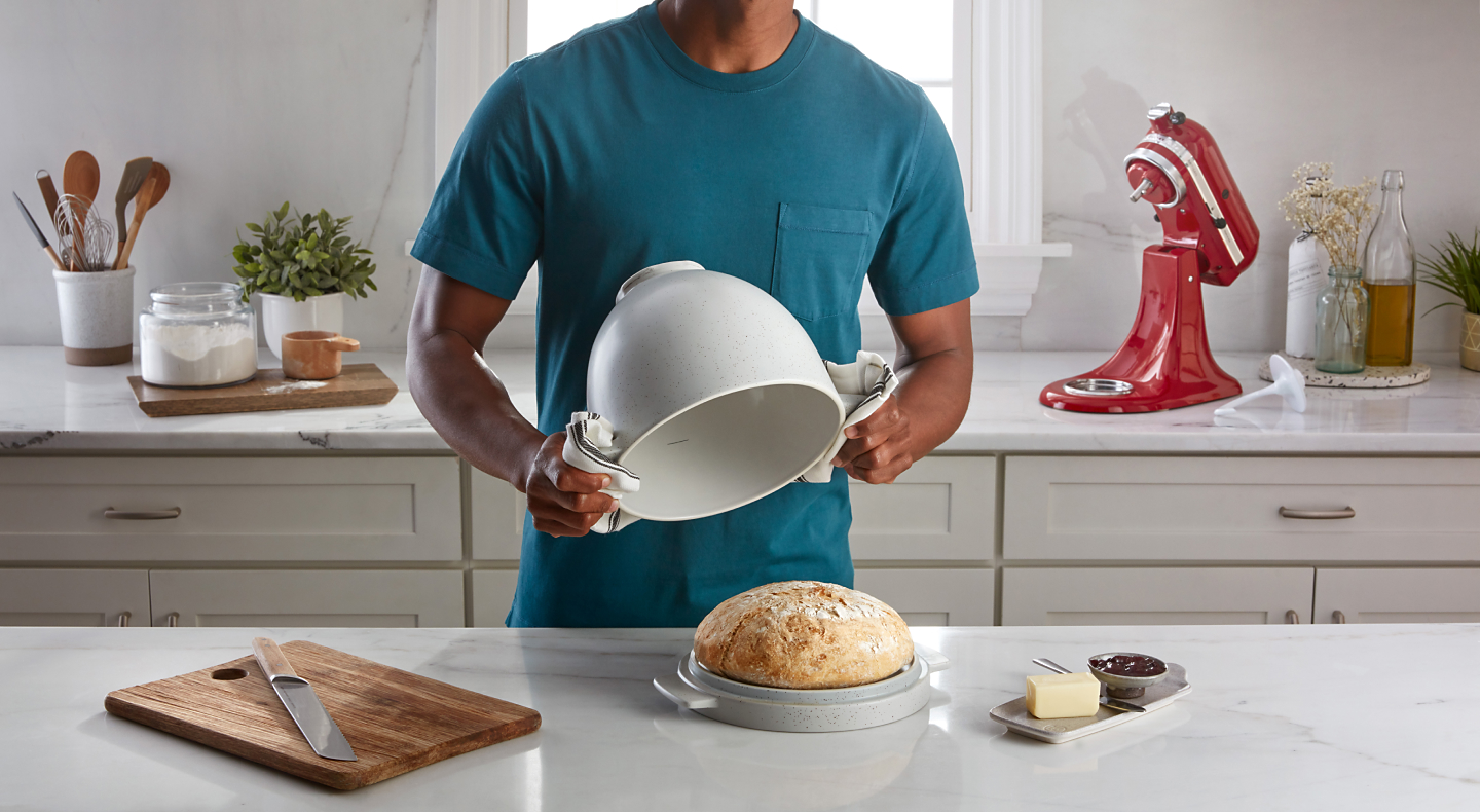 Person removing the KitchenAid® bread bowl off of a loaf of bread