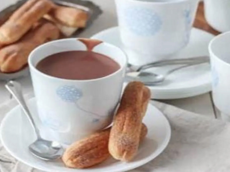 Eclairs next to a cup of coffee