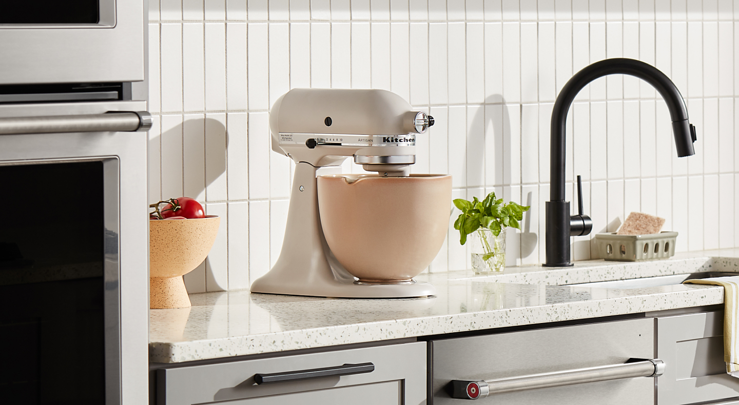 Cream KitchenAid® stand mixer with a beige mixing bowl 