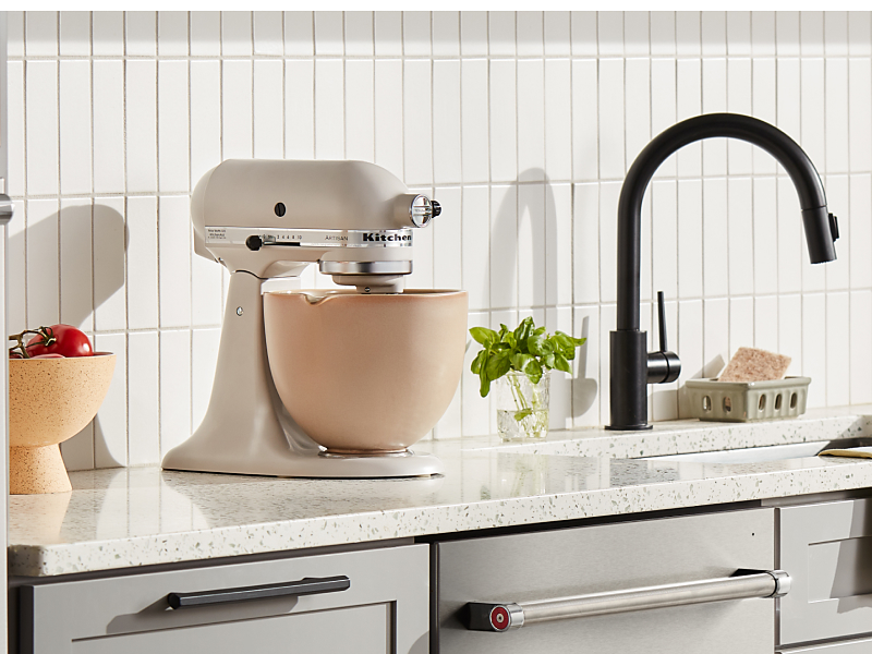 Cream KitchenAid® stand mixer with a beige mixing bowl 