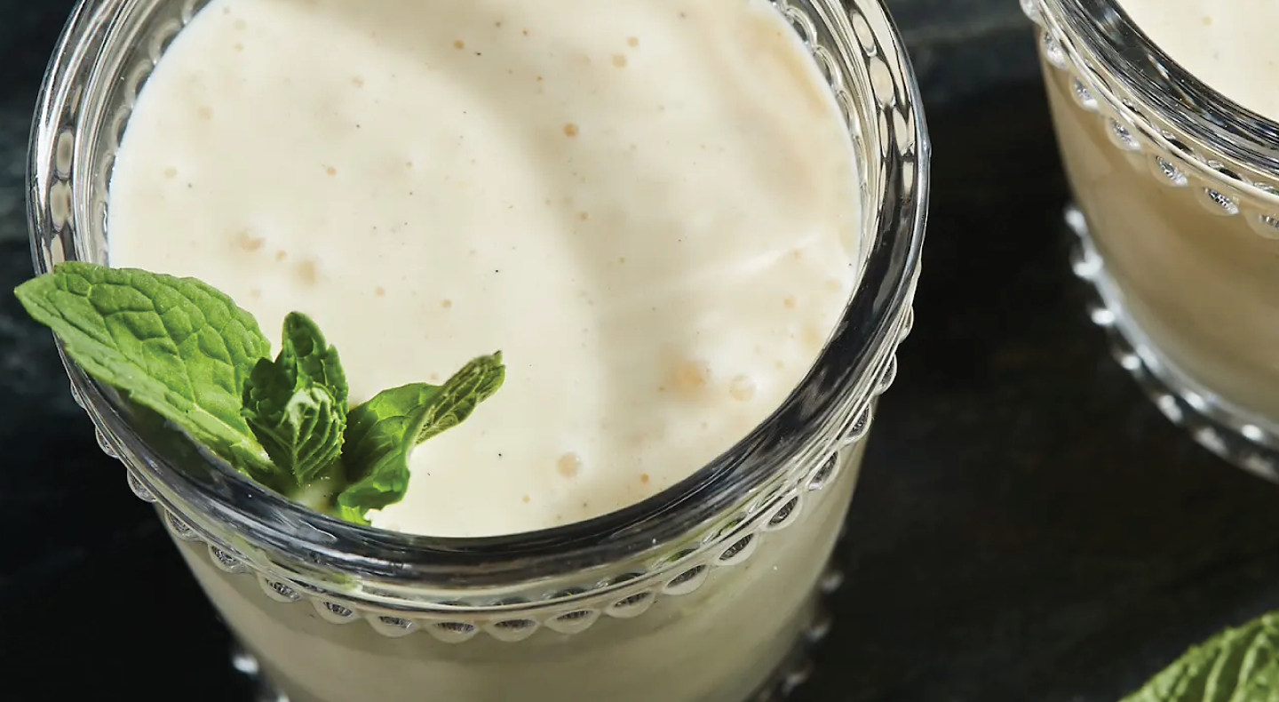 Close-up of white smoothie garnished with mint leaves