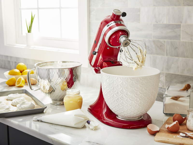 Red KitchenAid® stand mixer next to a tray of pastry dough
