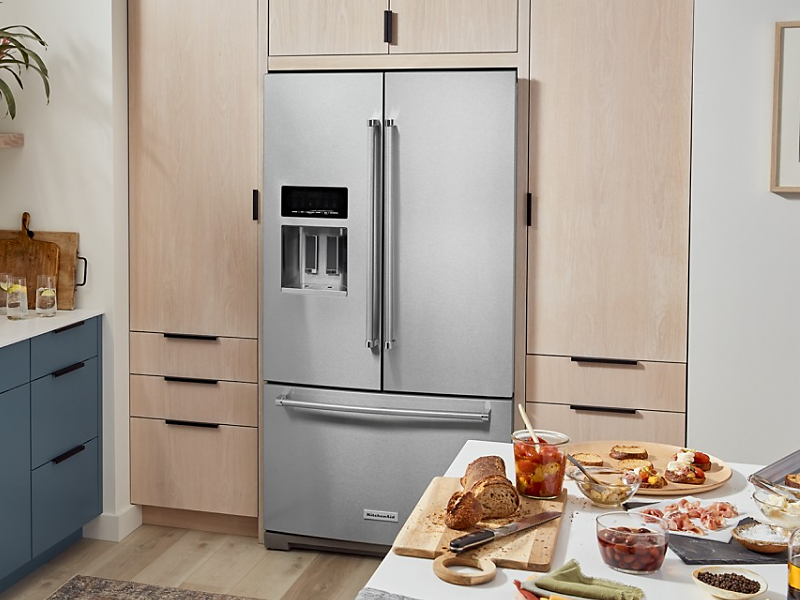 KitchenAid® French-door refrigerator in light brown cabinetry 