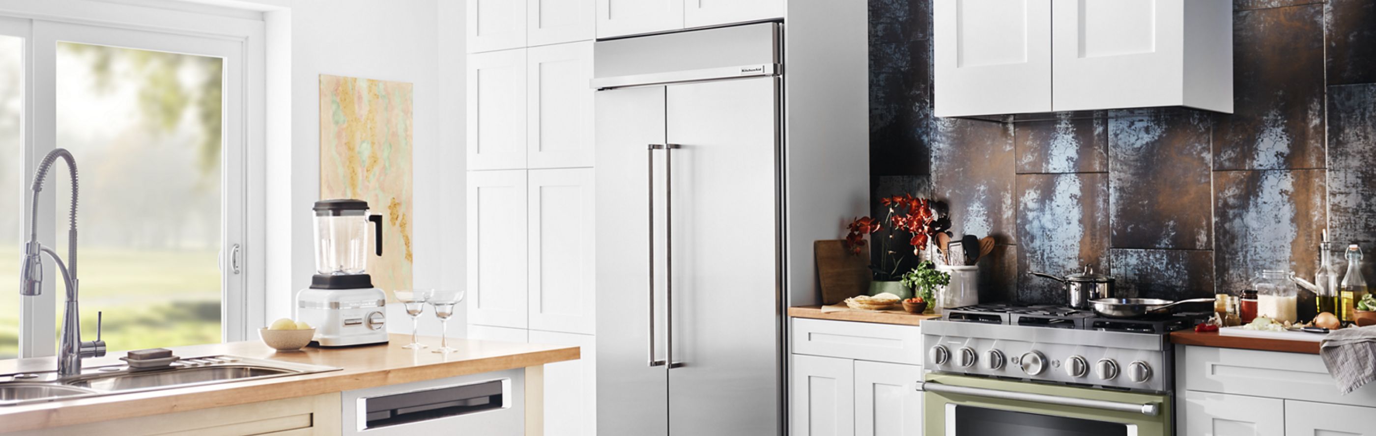 Built-in stainless steel KitchenAid® refrigerator in white cabinetry