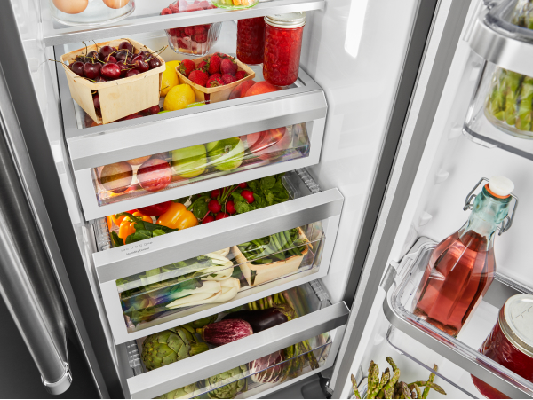 Open refrigerator door filled with food
