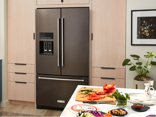 KitchenAid® French-door refrigerator built into light brown cabinetry