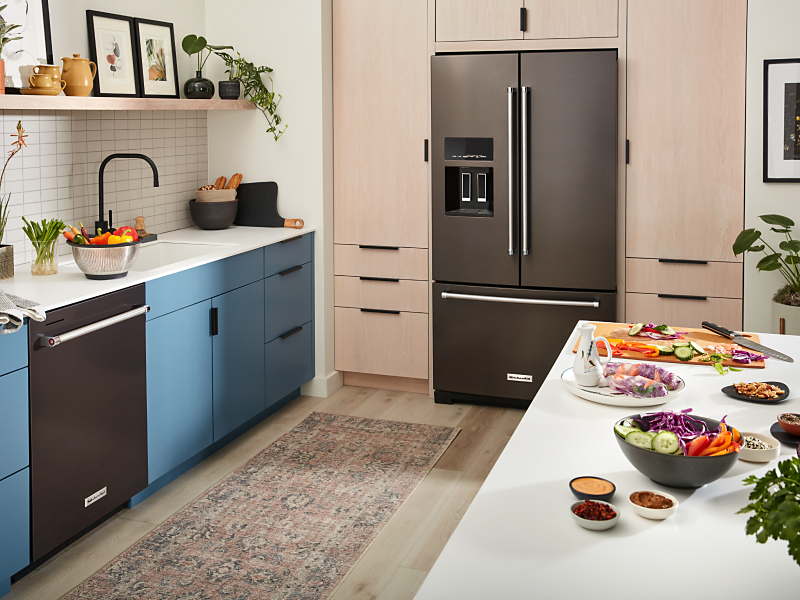 KitchenAid® French-door refrigerator with ice dispenser built into light brown cabinetry