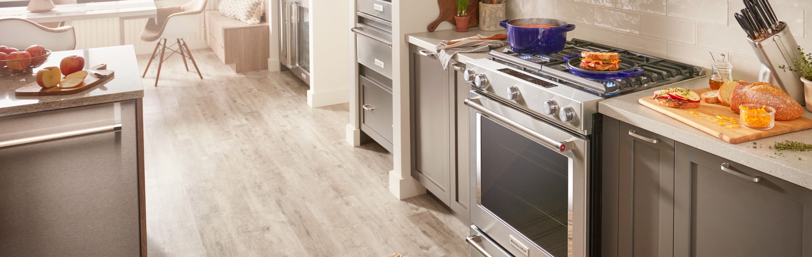 A KitchenAid® gas stove in the middle of a kitchen