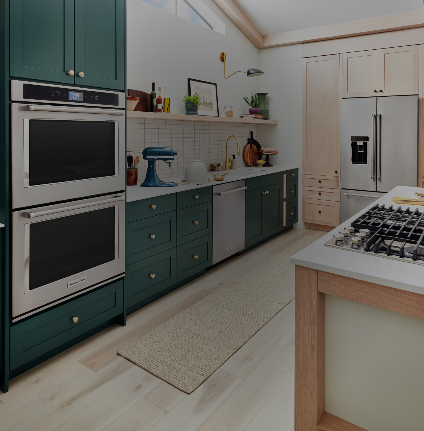 A kitchen with green cabinets and KitchenAid® appliances.