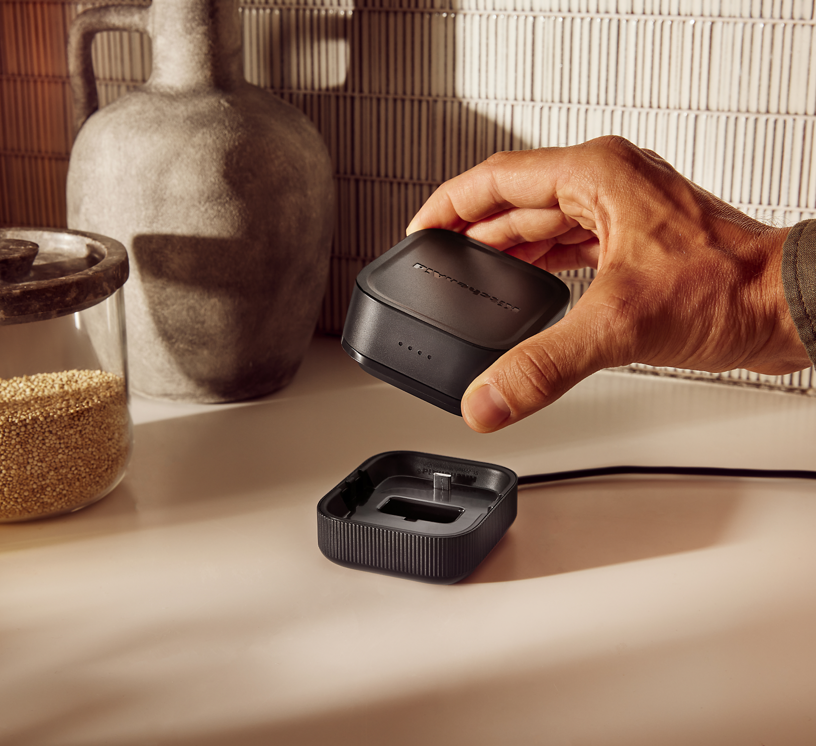 A person placing the KitchenAid Go™ Cordless 12V Max Lithium Ion Rechargeable Battery on the USB Charging Dock.