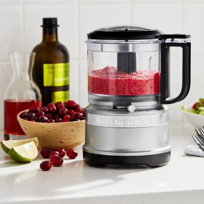 A KitchenAid® blender and a bowl of berries.