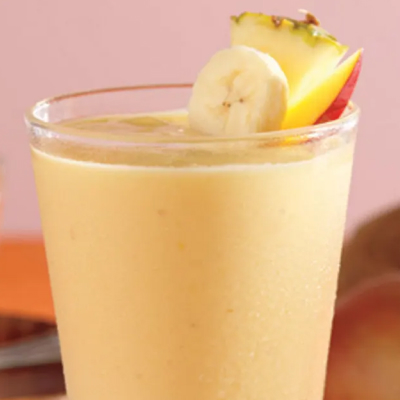 A tropical sunrise mocktails with pineapple and banana slices.