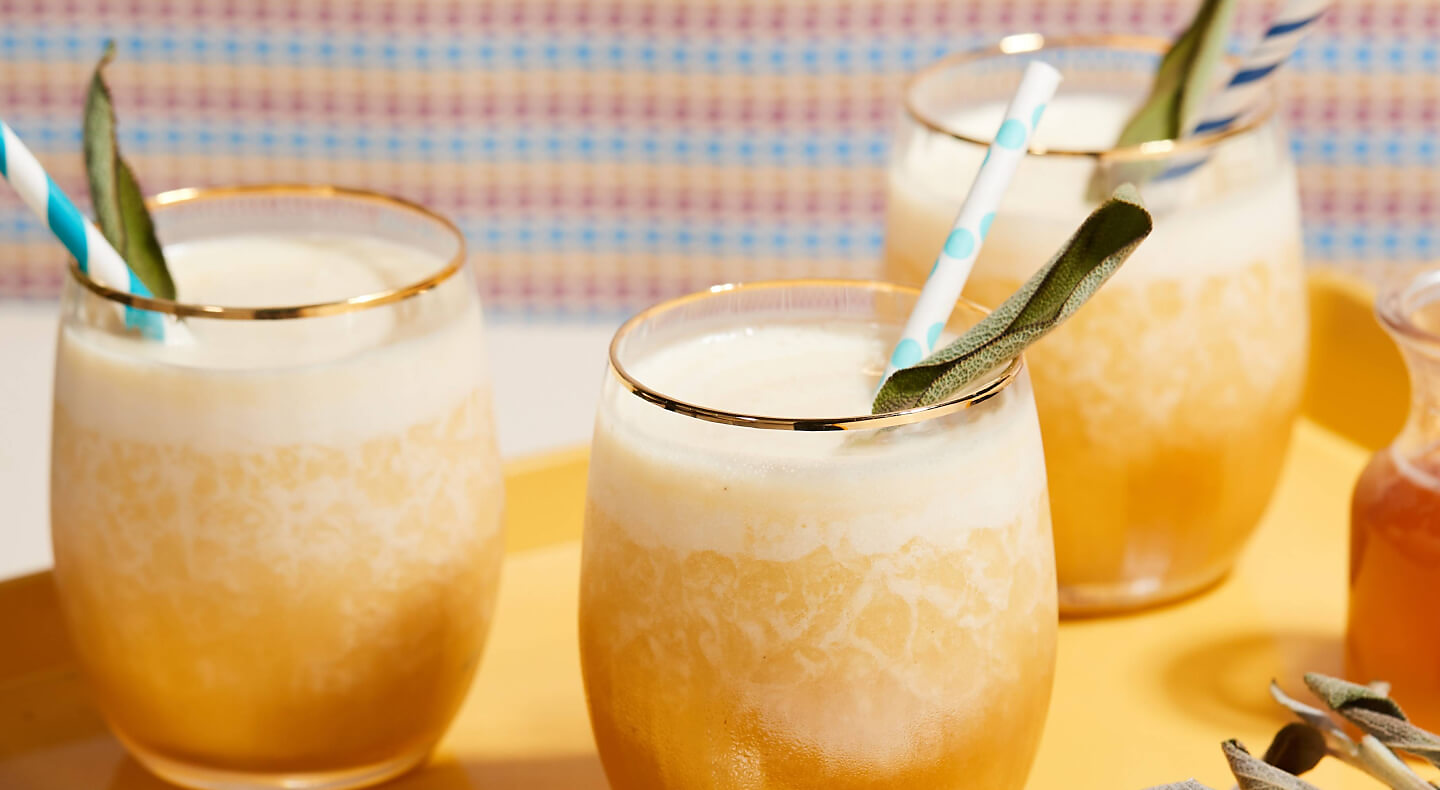 Three glasses of orange juice cocktails.